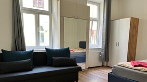 A modern room with a sofa, a bed, and a wardrobe. - Spacious 4BR Stay Vienna for Families (Vienna)
