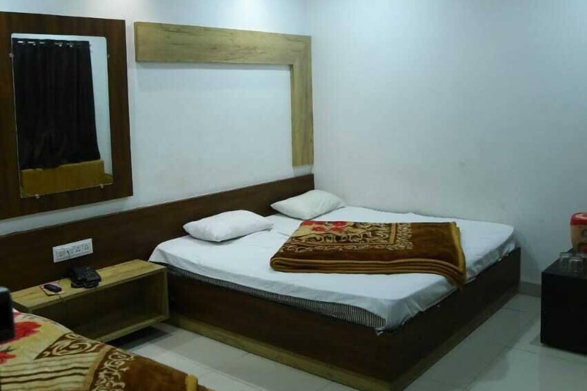 A bedroom with a bed, bedside table, and a ceiling fan.
