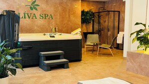 A spa reception area with a reception desk, a seating area with chairs, a small table, and a shower area.