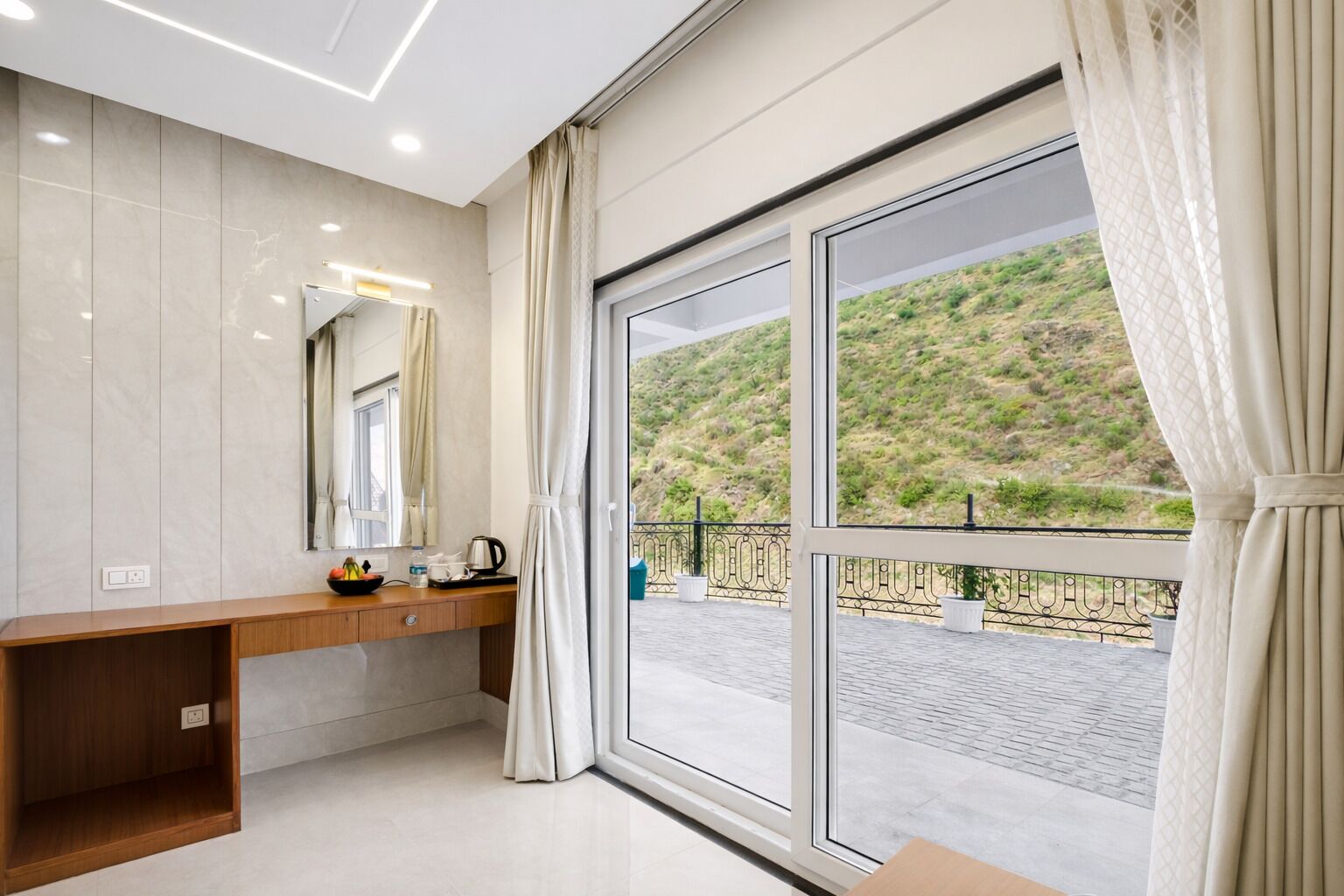 A modern bathroom with a large window, a wooden vanity, and a mirror.