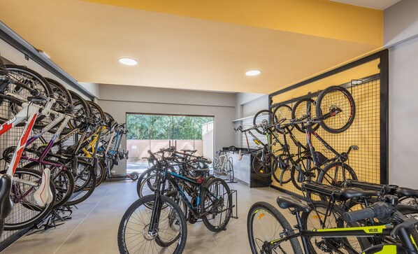 A bike storage area with multiple bicycles secured on racks.