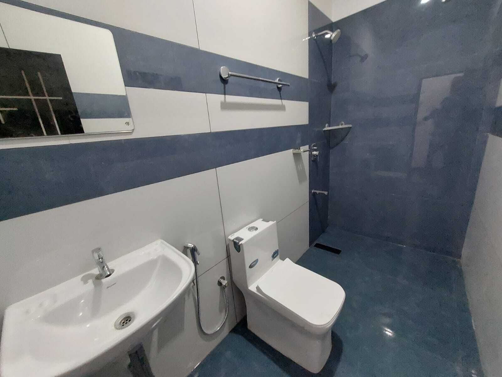 A bathroom with a sink, toilet, and shower.