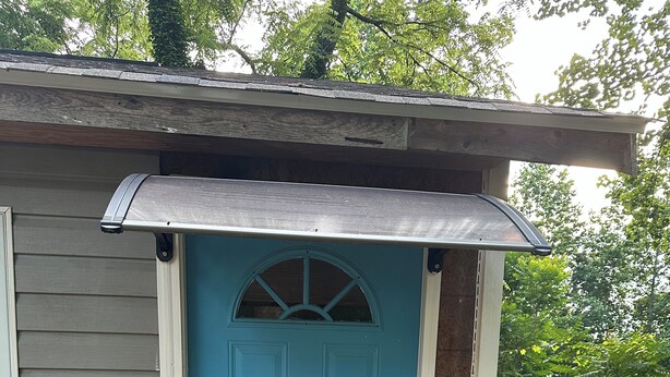 A blue door with a small window above it, a doormat with a message, and a wooden deck with a railing. - Private Studio 12min from. Mercedes Benz/Downtown (Atlanta)