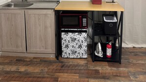 A kitchen with wooden cabinets, a sink, a microwave, a toaster, and a red coffee maker on a wooden countertop. - Private Studio 12min from. Mercedes Benz/Downtown (Atlanta)