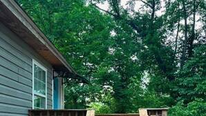 A wooden deck leading to a house surrounded by dense green foliage. - Private Studio 12min from. Mercedes Benz/Downtown (Atlanta)