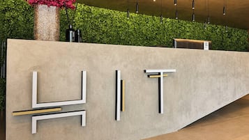 A reception desk with a modern design, featuring geometric shapes and a neutral color palette.