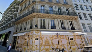 A multi-story building with a classic architectural style, featuring balconies and a prominent storefront with the brand name 'BENETTON'. - Two bedroom  in France, Paris (Paris)