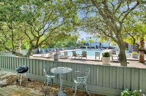 A backyard with a pool, outdoor furniture, and a barbecue grill. - Sandy Toes on Parks Edge (Orange Beach)