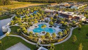 A resort with a central swimming pool, multiple villas, and lush landscaping. - Last Minute Disney Getaway! Luxury Villa with Private Pool, Game Room & Themed Bedrooms. Book Now! #159553 (Orlando)