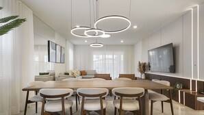 A modern dining area with a large wooden table, six chairs, and three pendant lights. - Last Minute Disney Getaway! Luxury Villa with Private Pool, Game Room & Themed Bedrooms. Book Now! #152617 (Orlando)