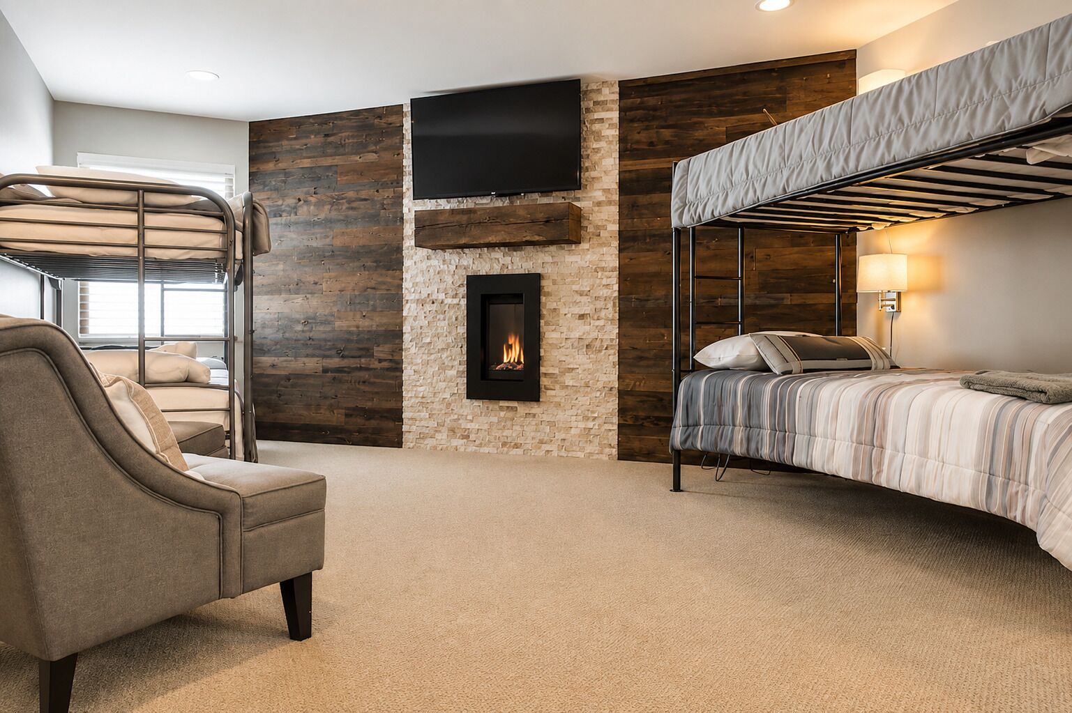 A room with a bunk bed, a fireplace, a television, and a sofa.