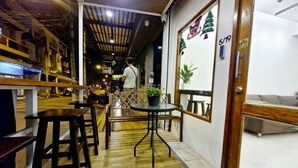 A hostel interior with wooden flooring, tables, and benches. - MaMa Hostel  CNX (Chiang Mai)