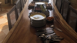 A dining table set for a meal with a view of a grassy area through an open doorway. - Magnificent family home, 7 bedrooms, 13 beds, 5' zoo Beauval (Seigy)