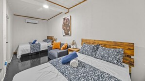 Et hotelværelse med to enkeltsenge, en sofa og et lille bord.