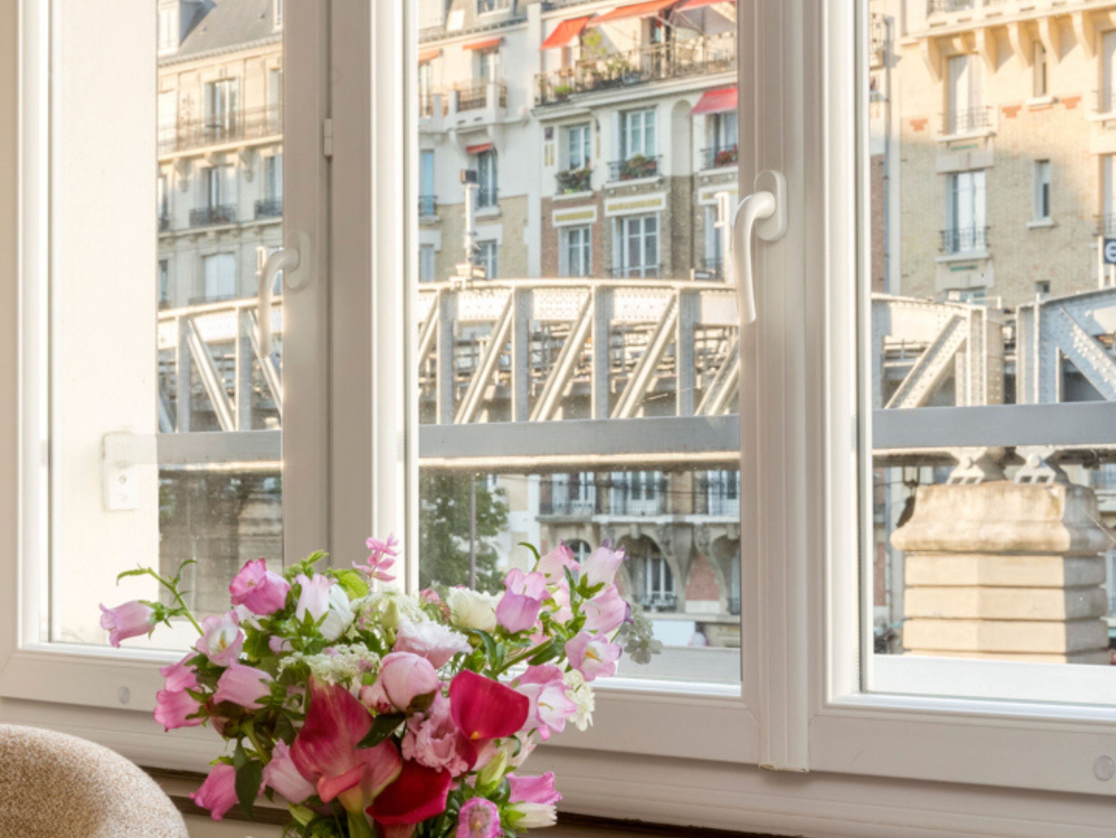 A window with a view of a bridge and buildings. - Signature Suite Eiffel Tower terrace (Paris)