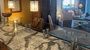 A modern kitchen with granite countertops, stainless steel appliances, and pendant lighting. - Waterfront, Direct View/Access, 2/2 TownHome, Grnd Level w Dock in Key Largo, FL (Key Largo)