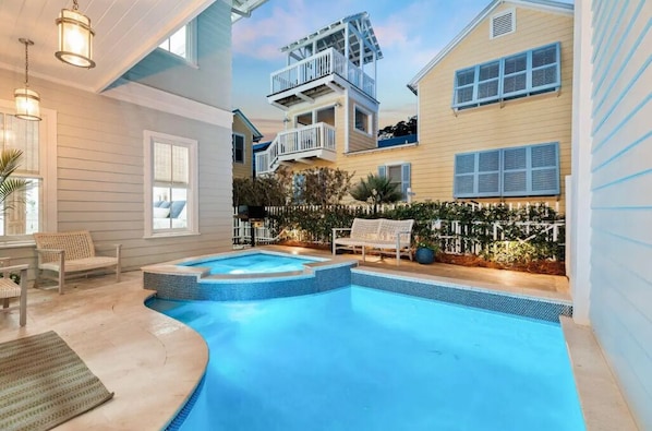 A swimming pool with a built-in deck, a covered outdoor seating area, and a multi-level balcony. - Sea La Vie Seaside Main House (Santa Rosa Beach)