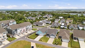 A residential area with houses, roads, and a body of water in the background. - Resort-Style Living in Beaufort’s Coolest Coastal Community (Beaufort)