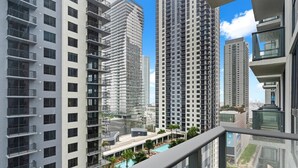 A high-rise residential building with multiple balconies, a swimming pool, and a clear view of the surrounding area. - City Views Downtown Miami (Miami)
