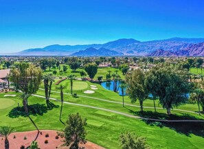 A golf course with a pond, trees, and mountains in the background. - Gorgeous house with private pool/hot tub in a gated community in Bermuda Dunes. (Bermuda Dunes)