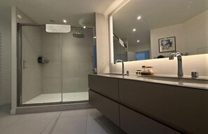 Shower, hair dryer, towels, soap - BATHED IN NATURAL LIGHT & BOASTING UNOBSTRUCTED VIEWS OF NOTRE DAME (Paris)
