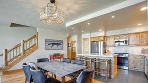 A spacious kitchen with wooden cabinets, a large island, and modern appliances. - Walk to Lift! Luxe, Updated CBMR Home w/ Mtn Views (Gunnison)