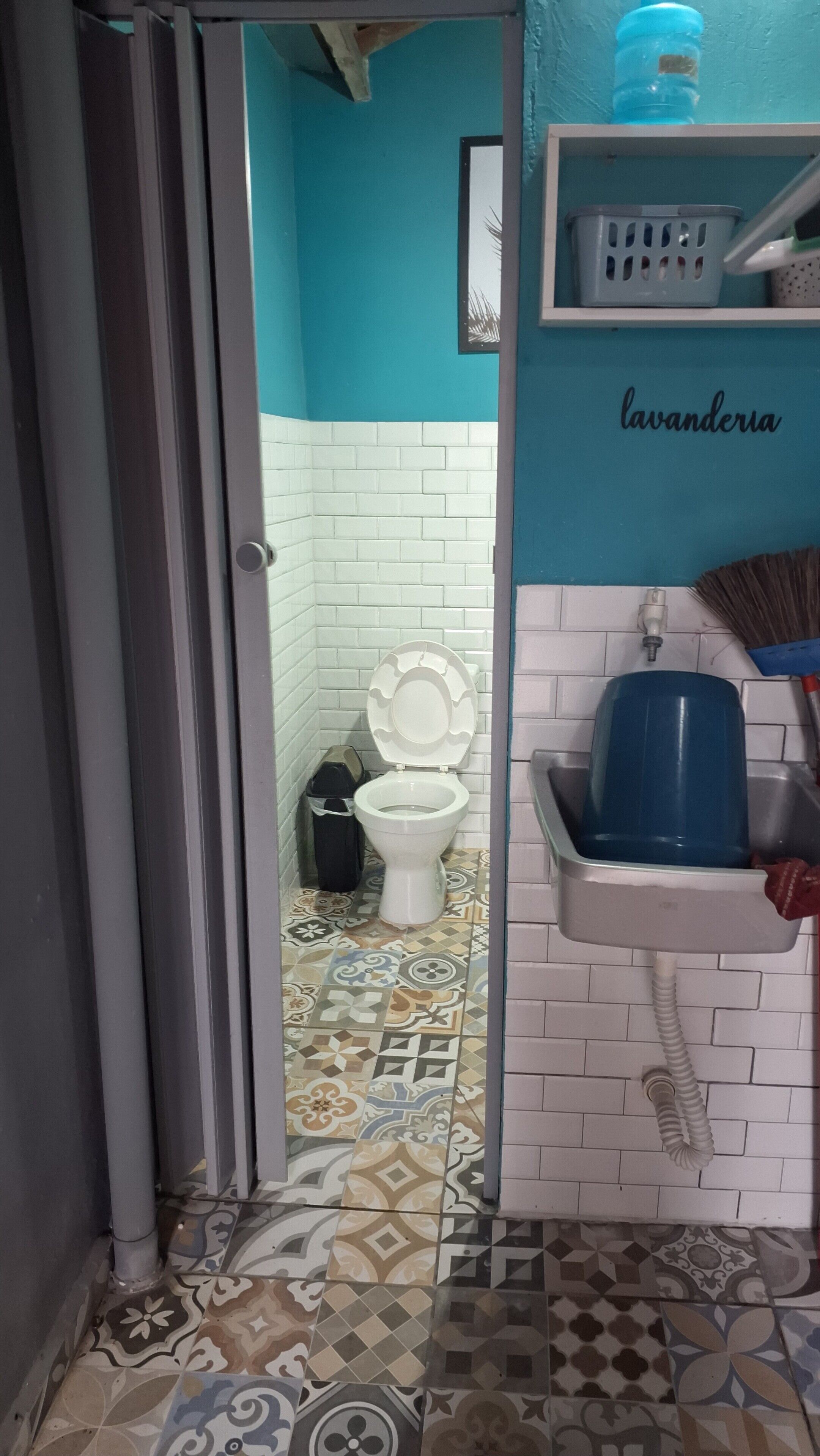 A bathroom with a toilet, a sink, and a shower area.