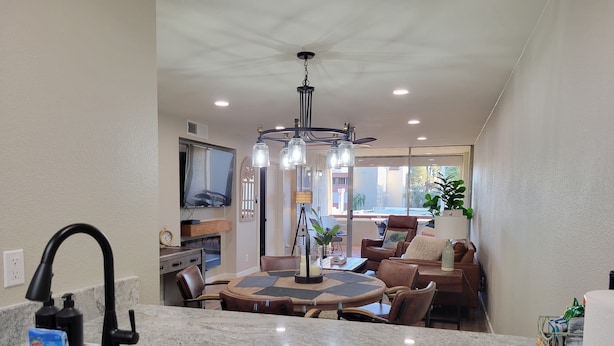 A kitchen with granite countertops, a stainless steel sink, and a dining area with a round table and chairs. - New Listing with Premier Host Luxury Meets Comfort Walk to Old Town Heated Pool (SCOTTSDALE)
