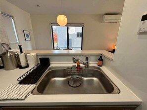 Fridge, cookware/dishes/utensils - Near Airport and Aso Volcano Modern 4BR Residence by Restavio (Ozu)