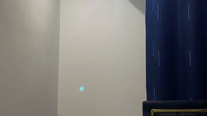 A room with a ceiling light, a projector mounted on the wall, and a dark curtain. - Lovely 2-bedroom in Nairobi near Yaya Centre — Everything Walkable (Nairobi)