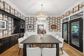 Gather around the elegant dining table beneath a statement chandelier for special meals together. - Lake Norman Estate • Hot Tub + Fire Pit + Movie Theater | Lion Manor (Denver)