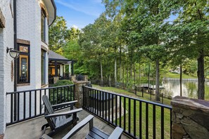 A residential property with a balcony, outdoor seating, and a view of a lake. - Spacious Lake Norman Home • Hot Tub + Firepit + Deck | Sleeps 22 | Lion Manor (Denver)