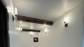 A spacious room with a high ceiling, exposed wooden beams, and recessed lighting. - The Lava White House - Sleeps 50+ (Lava Hot Springs)