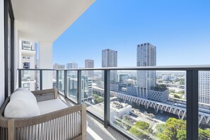 A balcony with a wicker sofa and a city view. - Downtown Brickell - Desirable Location - We Host (Miami)