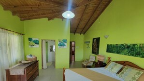 A room with a bed, a wooden dresser, a chair, and a painting on the wall. - Spacious house located in Vieux Fort, few minutes from Hewanorra Airport (Vieux Fort)