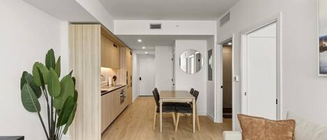 A modern apartment with a kitchen, dining area, and living room.