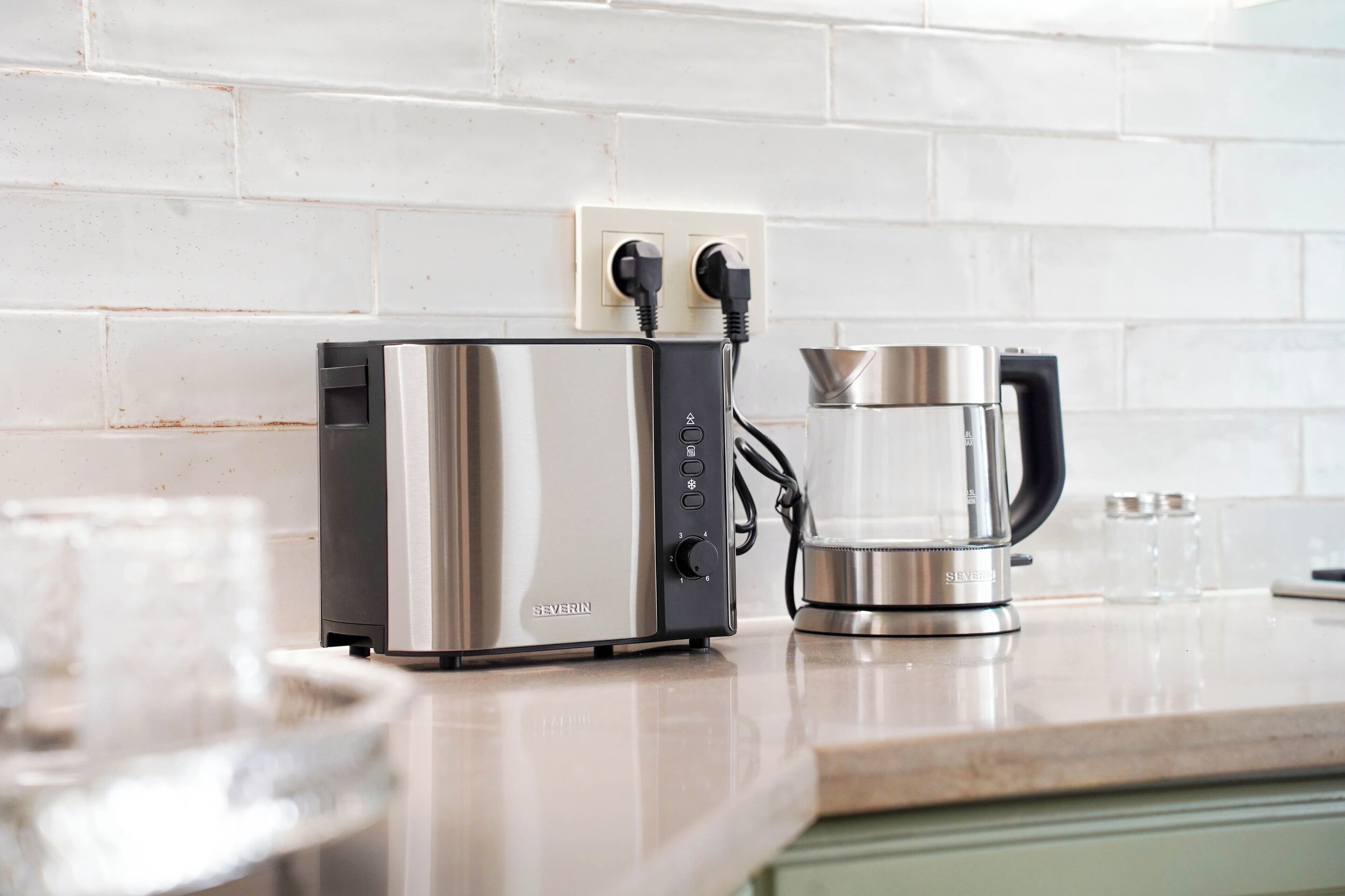 A kitchen with a modern coffee maker and a toaster on the counter.