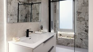 A modern bathroom with a white sink, black faucet, and a glass shower enclosure. - AlexandraDesignSuite (Carpi)
