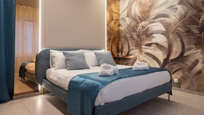 A modern bedroom with a large bed, a wall mural, and a bedside table. - AlexandraDesignSuite (Carpi)