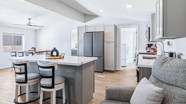 A modern kitchen with a central island, bar stools, and a built-in refrigerator. - 4 BDR 2 mins from the River- Sleeps 12 (Bullhead City)