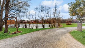 A gravel path leading to a lake with cabins and a sign indicating Blue Line Resort. - Pet Friendly! Couples Retreat in Southern Illinois (Murphysboro)
