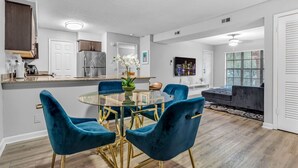 A modern kitchen with white cabinets, a stainless steel refrigerator, and a built-in oven. - Serene Waterfront 2BR  Poolside Living in Fort Lauderdale (Fort Lauderdale)
