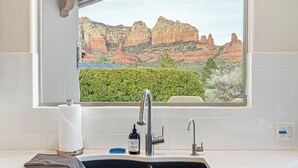 A kitchen with a window view of red rock formations. - Experience luxury at Sedona Willow Villa—spacious 3BR home with stunning Red Rock views! (Sedona)