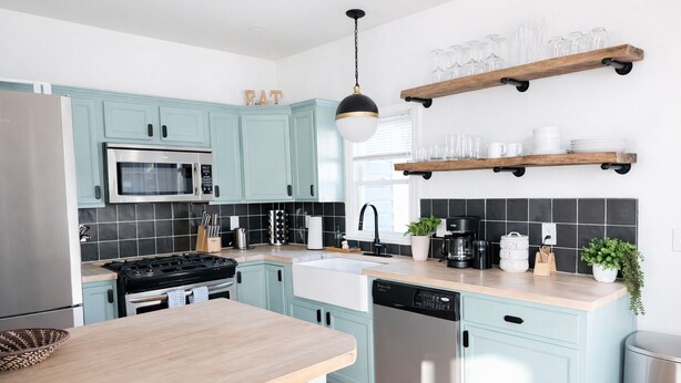 A modern kitchen with light blue cabinets, stainless steel appliances, and wooden countertops. - Historic 2-bedroom house close to beltline in Cabbagetown, Atlanta (Atlanta)