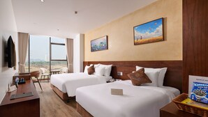 A hotel room with two beds, a desk, a chair, a TV, and a large window with a view. - Elegance Ninh Binh Hotel  (Ninh Binh)