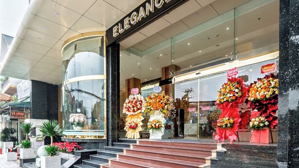 The entrance of the Elegance Hotel with a modern facade, a glass entrance, and a set of stairs leading up to the door. - Elegance Ninh Binh Hotel  (Ninh Binh)