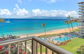A hotel with a pool, beach view, and palm trees. - Maui Resort Rentals: The Whaler 762 - 7th-Floor Studio, Stunning Pacific Ocean and Black Rock Views! (Lahaina)