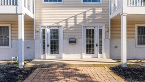 A two-story building with a central entrance, double doors, and a small mailbox. - 3 Bedroom Condo Near Wildwood Beach & Boardwalk (Wildwood)