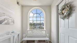 A white bench with baskets, a white door, and a window with a view. - 3 Bedroom Condo Near Wildwood Beach & Boardwalk (Wildwood)