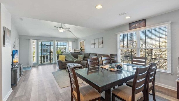 A spacious living area with a dining table, chairs, a sofa, and a ceiling fan. - 3 Bedroom Condo Near Wildwood Beach & Boardwalk (Wildwood)